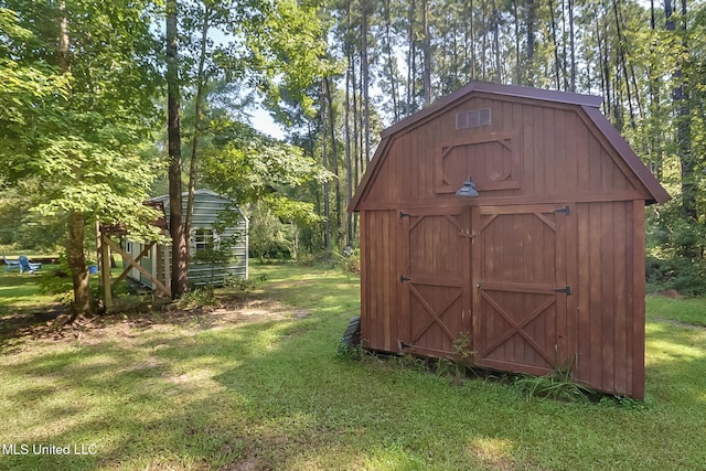 view of outdoor structure featuring a lawn