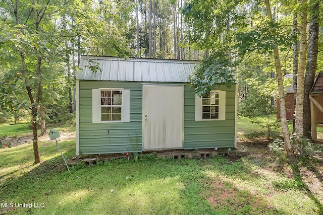 view of outbuilding featuring a lawn