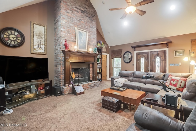 living room with ceiling fan, carpet floors, high vaulted ceiling, and a brick fireplace