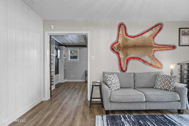 living room with baseboards and wood finished floors