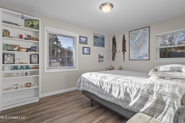 bedroom with baseboards and wood finished floors