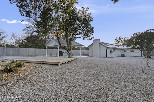 view of yard with fence, a deck, and a gazebo