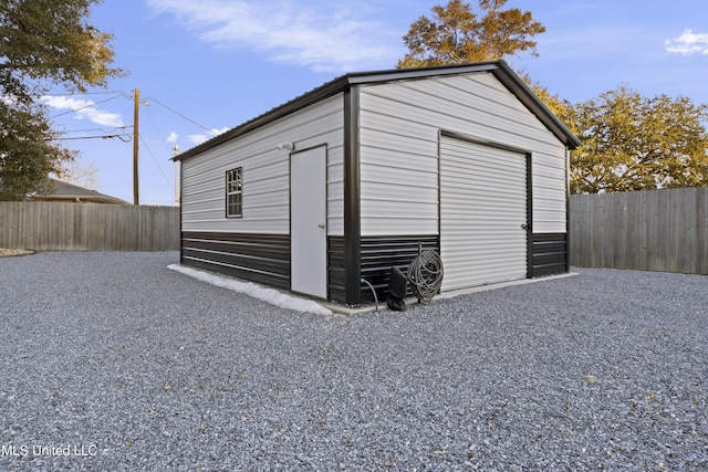 view of outdoor structure featuring a fenced backyard and an outdoor structure