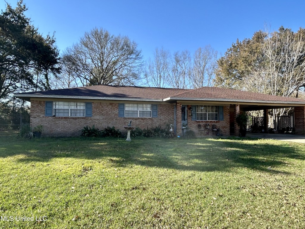 ranch-style house featuring an attached carport, brick siding, and a front lawn