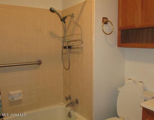 full bath with washtub / shower combination and toilet