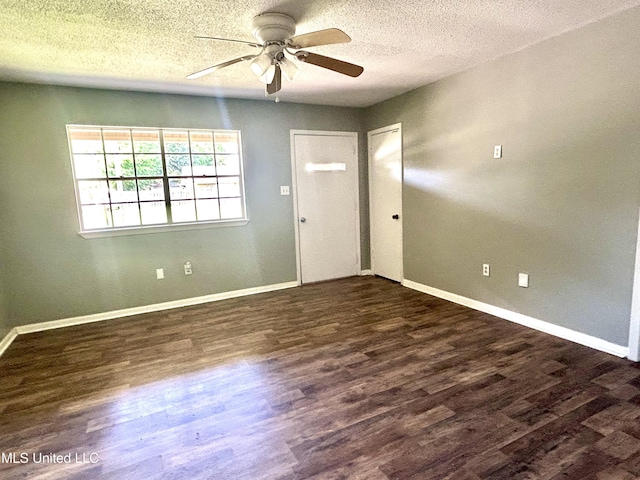 entryway featuring baseboards, a ceiling fan, a textured ceiling, and wood finished floors
