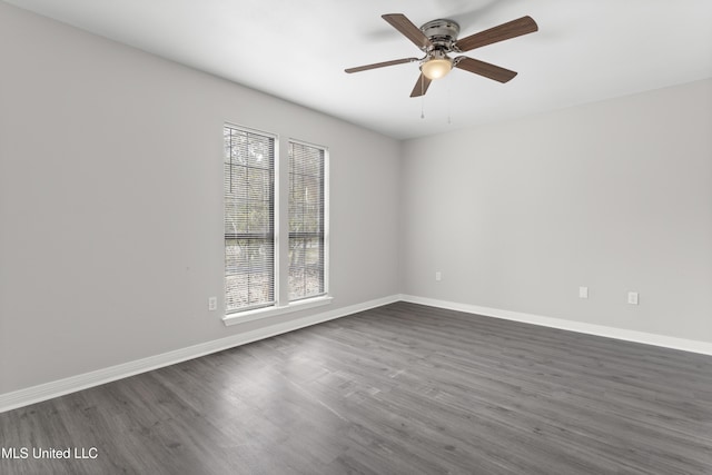 empty room with dark wood-type flooring and ceiling fan