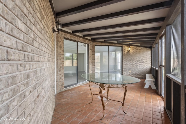 sunroom featuring beamed ceiling