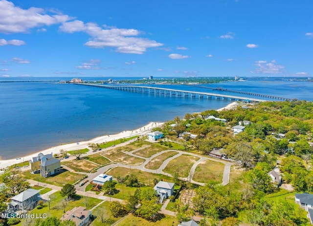 drone / aerial view featuring a water view and a view of the beach