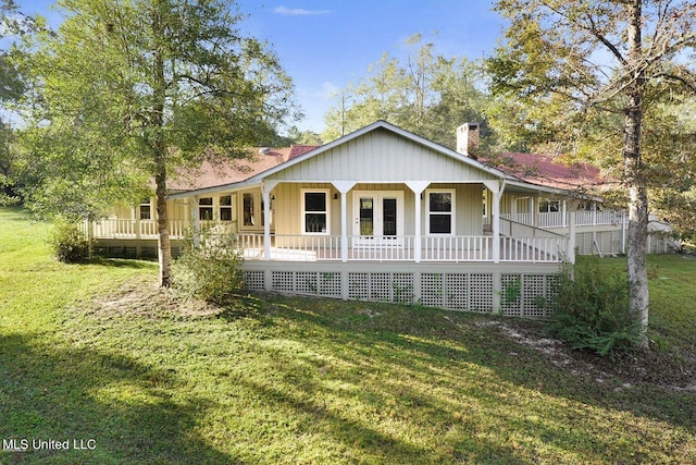 18153 Doc Lizana Rd, Gulfport, MS 39503 - view of front facade with a porch, a front lawn, and a chimney