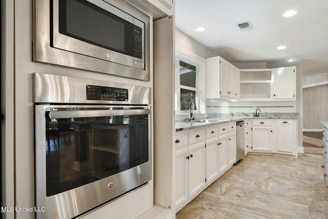 18153 Doc Lizana Rd, Gulfport, MS 39503 - kitchen with a sink, open shelves, visible vents, light stone counters, and appliances with stainless steel finishes