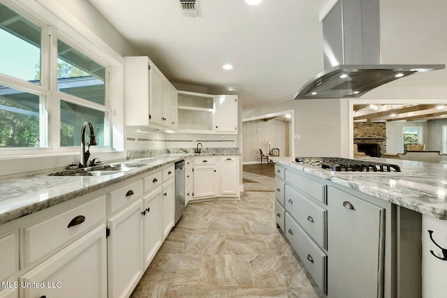 18153 Doc Lizana Rd, Gulfport, MS 39503 - kitchen with stainless steel appliances, open shelves, white cabinets, a sink, and island exhaust hood