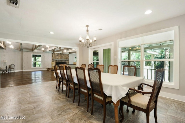 18153 Doc Lizana Rd, Gulfport, MS 39503 - dining area featuring recessed lighting, a fireplace, a notable chandelier, visible vents, and baseboards