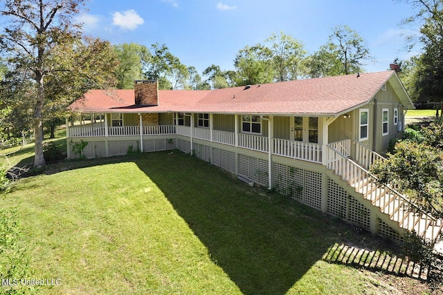 18153 Doc Lizana Rd, Gulfport, MS 39503 - rear view of house featuring a yard, a chimney, covered porch, stairs, and roof with shingles