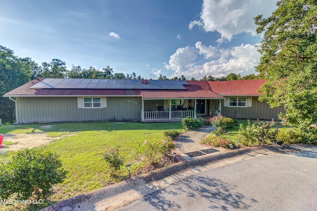 18153 Doc Lizana Rd, Gulfport, MS 39503 - ranch-style home with roof mounted solar panels, covered porch, and a front yard