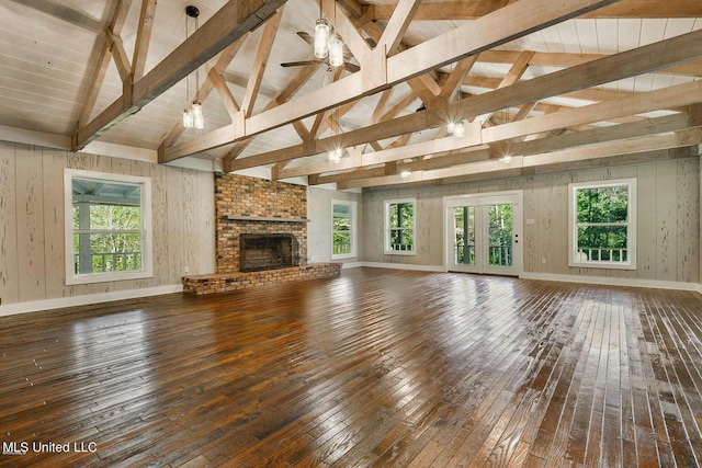 18153 Doc Lizana Rd, Gulfport, MS 39503 - unfurnished living room featuring lofted ceiling with beams, a ceiling fan, hardwood / wood-style flooring, and a fireplace