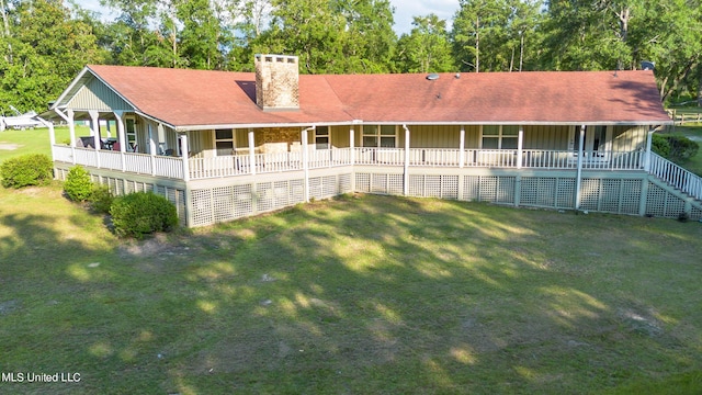 18153 Doc Lizana Rd, Gulfport, MS 39503 - rear view of house featuring covered porch, board and batten siding, a chimney, and a yard