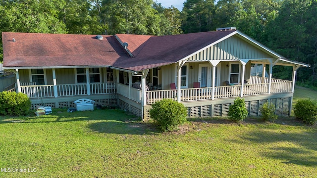 18153 Doc Lizana Rd, Gulfport, MS 39503 - view of front of house with a porch, a front lawn, board and batten siding, and roof with shingles