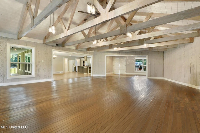 18153 Doc Lizana Rd, Gulfport, MS 39503 - unfurnished living room featuring plenty of natural light, hardwood / wood-style floors, vaulted ceiling with beams, and baseboards