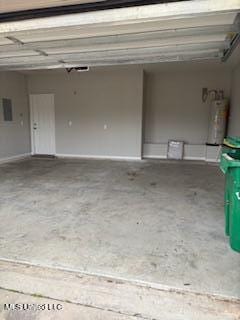 garage featuring electric panel and water heater