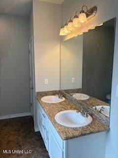 bathroom with a sink and double vanity