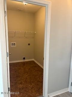 laundry area with baseboards, laundry area, and hookup for an electric dryer