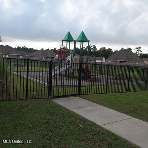 community playground with a lawn and fence