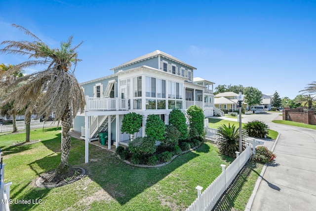 view of side of home featuring a yard and a sunroom