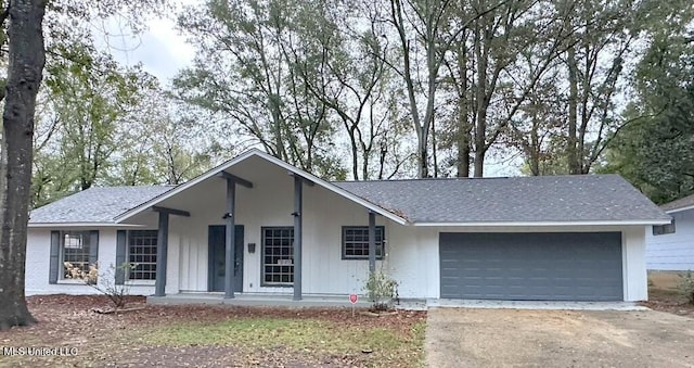 ranch-style home with covered porch and a garage