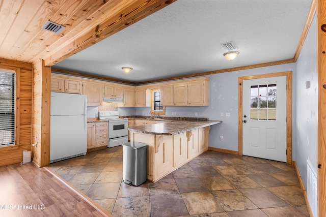 kitchen featuring white appliances, light brown cabinetry, sink, kitchen peninsula, and crown molding