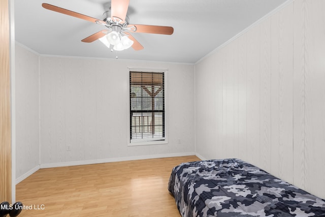 bedroom featuring crown molding, hardwood / wood-style flooring, and ceiling fan