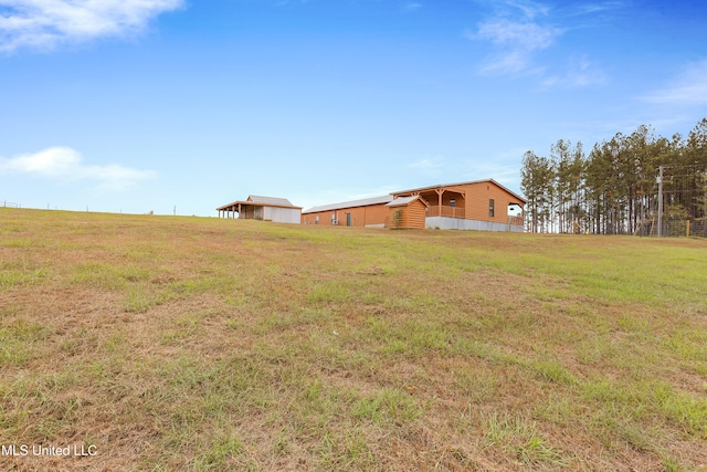 view of yard with a rural view