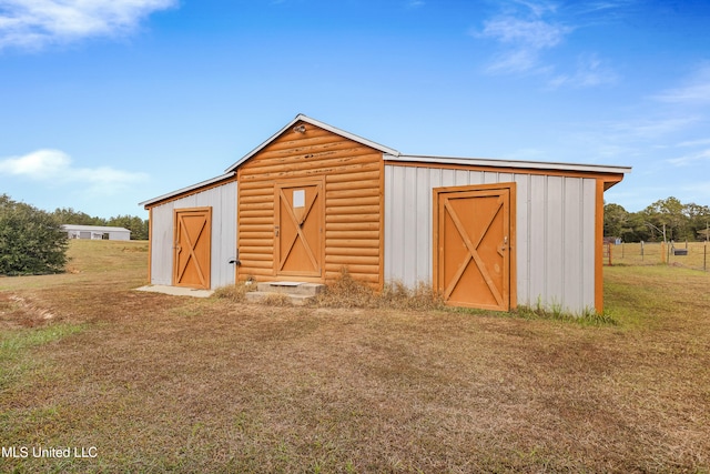 view of outbuilding featuring a yard