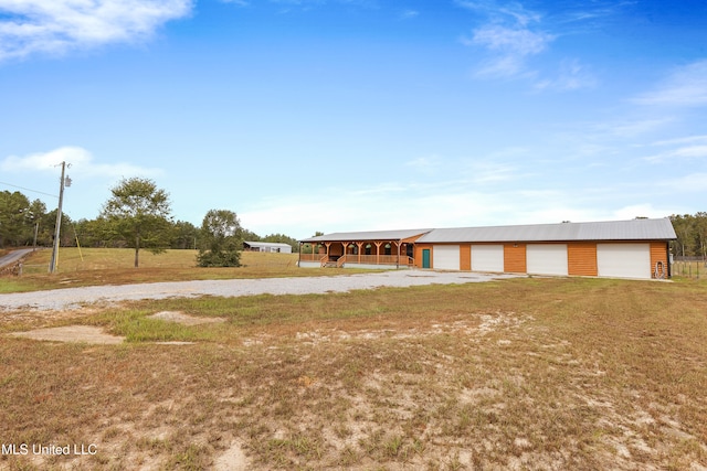 view of front of property featuring an outbuilding and a garage