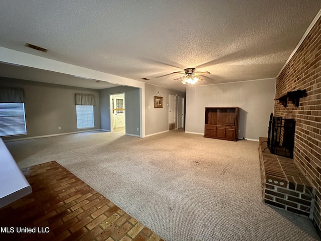 3427 Jr Davis Rd, Moss Point, MS 39562 - unfurnished living room featuring baseboards, a fireplace, visible vents, and carpet floors