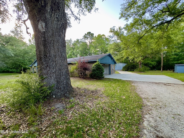 3427 Jr Davis Rd, Moss Point, MS 39562 - view of property exterior featuring concrete driveway, a garage, and a lawn