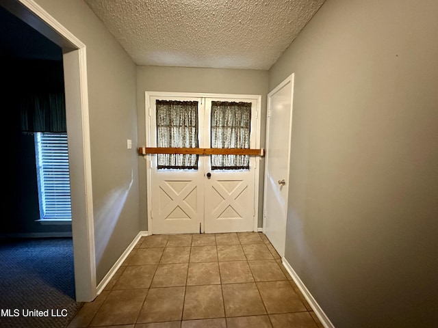3427 Jr Davis Rd, Moss Point, MS 39562 - entryway featuring baseboards, tile patterned flooring, and a textured ceiling