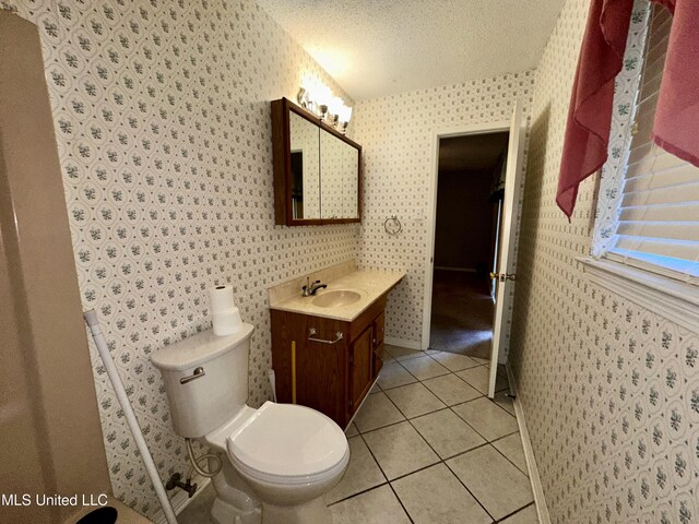 3427 Jr Davis Rd, Moss Point, MS 39562 - half bath with tile patterned floors, wallpapered walls, toilet, and a textured ceiling