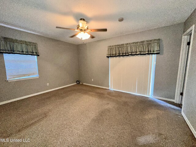 3427 Jr Davis Rd, Moss Point, MS 39562 - carpeted empty room featuring a textured ceiling, baseboards, and a ceiling fan