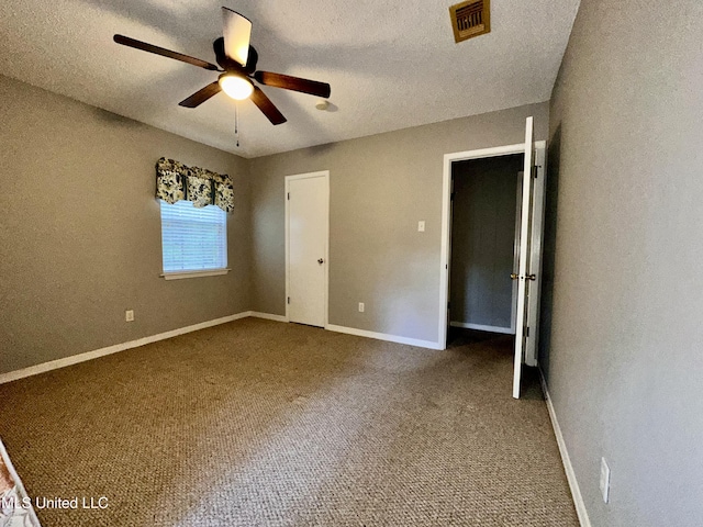 3427 Jr Davis Rd, Moss Point, MS 39562 - unfurnished bedroom with a textured ceiling, visible vents, baseboards, and carpet floors