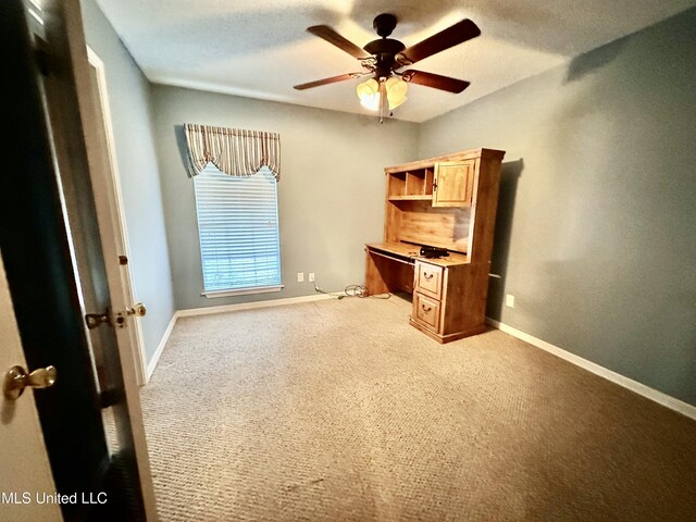3427 Jr Davis Rd, Moss Point, MS 39562 - unfurnished office with baseboards, light carpet, and a ceiling fan