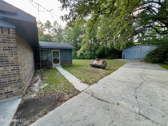 3427 Jr Davis Rd, Moss Point, MS 39562 - view of yard featuring driveway, an outbuilding, and a detached garage