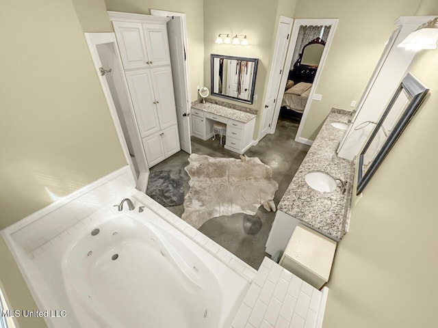 bathroom with double vanity, baseboards, ensuite bath, a tub with jets, and a sink