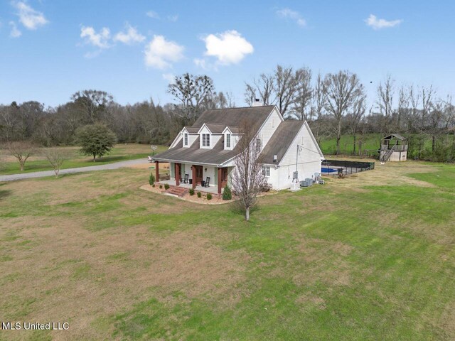 view of front of property with a porch and a front lawn