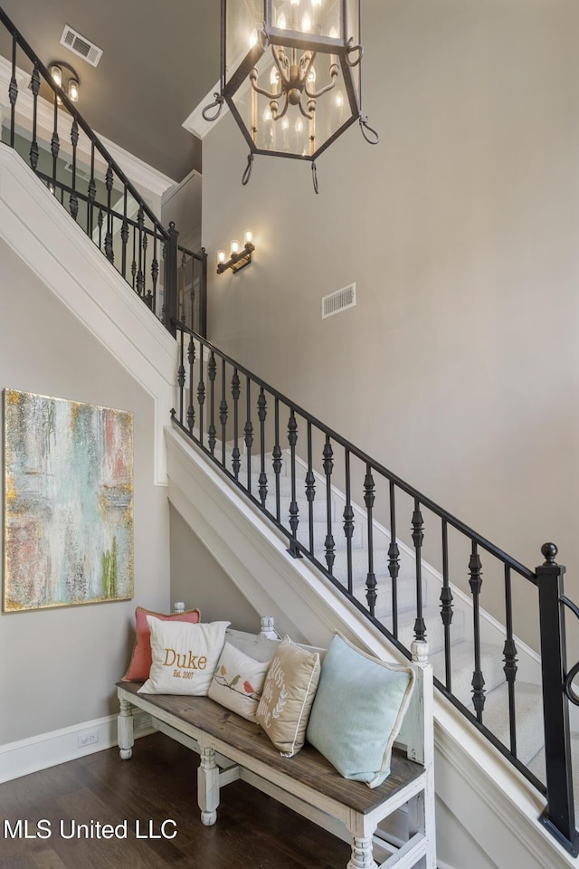 340 Sherborne Pl, Flowood, MS 39232 - stairs with wood finished floors, a high ceiling, baseboards, and a chandelier