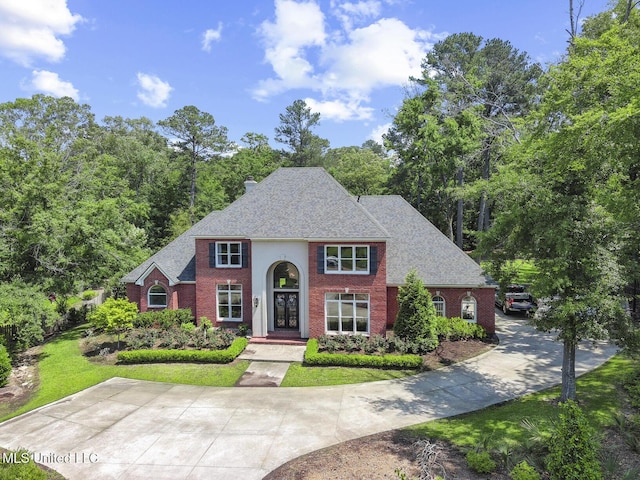 340 Sherborne Pl, Flowood, MS 39232 - view of front of property with brick siding, driveway, a front yard, and roof with shingles