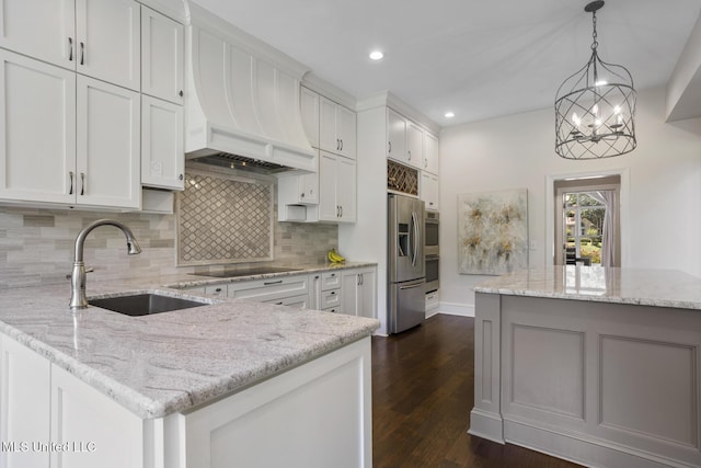 340 Sherborne Pl, Flowood, MS 39232 - kitchen with a sink, custom exhaust hood, backsplash, a peninsula, and stainless steel appliances