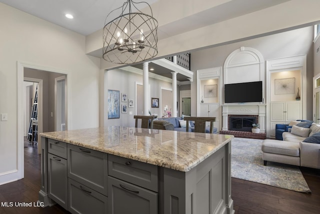 340 Sherborne Pl, Flowood, MS 39232 - kitchen with gray cabinetry, open floor plan, light stone counters, dark wood-style flooring, and a high ceiling