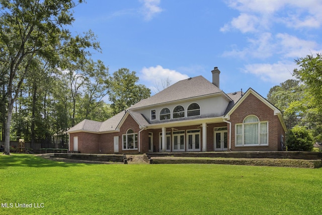 340 Sherborne Pl, Flowood, MS 39232 - rear view of house with french doors, brick siding, a lawn, and a chimney