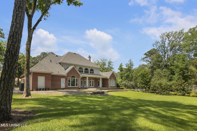 340 Sherborne Pl, Flowood, MS 39232 - view of front facade with brick siding, a front yard, roof with shingles, and central air condition unit